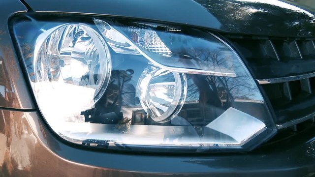 Car Headlights Turning On. Zoom In. 