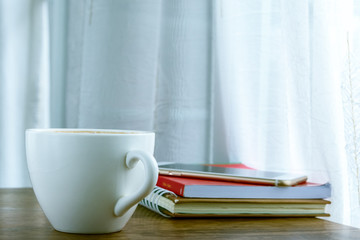 Coffee cup top view on wooden table.