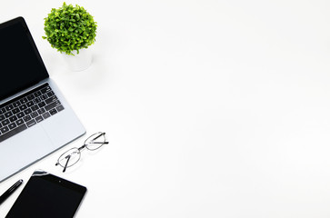 Laptop,tablet,smartphone on White desk Copy space  