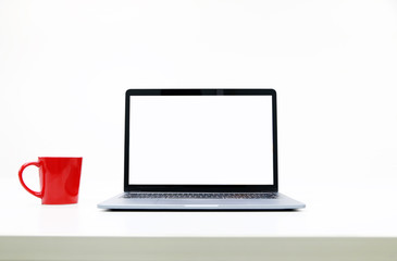 Fototapeta premium blank Screen Laptop and Red Coffee Cup in modern office
