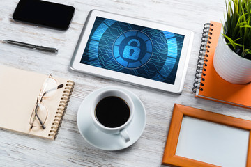 Web security and technology concept with tablet pc on wooden table