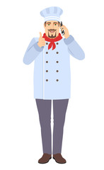 Chef showing thumb up and talking on the mobile phone