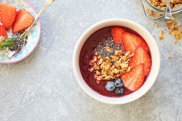 
    Smoothie. Berrie smothie with granola, chia seeds, strawberry and blueberry topping. Super food, clean eating,plant based concept. 