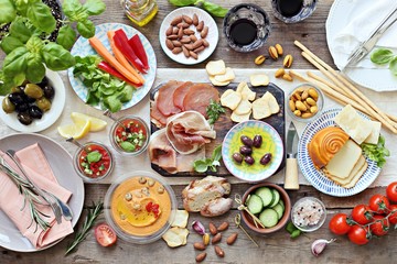 
    Mediterranean appetizers table concept. Dinner table with tapas selection: cured meat and...