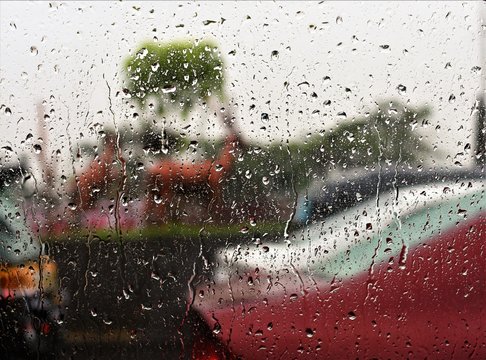 Drops of water on the car window ona rainy cloudy day in Mumbai, India
