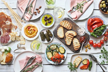 
    Mediterranean appetizers table concept. Dinner table with tapas selection: cured meat and...