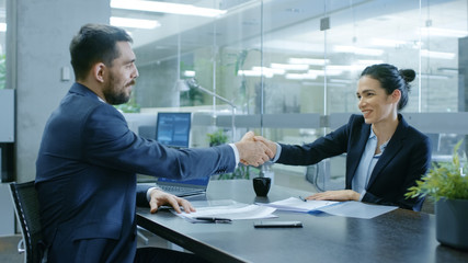 Businesswoman and Businessman Shake Hands. Draw up a Contract, Filling Papers in Conference Room....