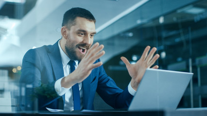 Handsome Businessman Works on a Laptop at His Desk, He Finished Job, Broke the Jackpot, Won Big and...