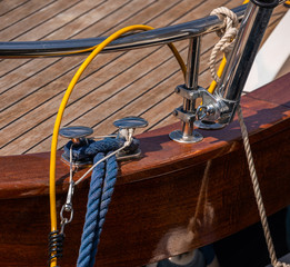 dock cleat on the side of a boat in a small marina, an element of yachting equipment