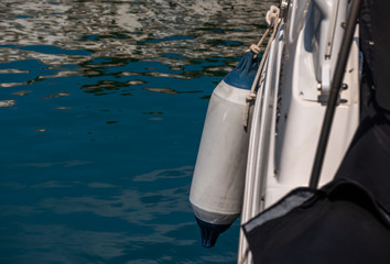 Fototapeta na wymiar buoy hanging outside the hull of the boat, boat equipment