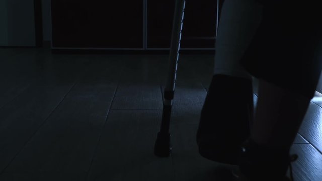  accident, discomfort, difficulty. walking with crutches at night - slow motion