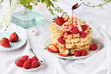 Waffles with fresh seasonal berries and whipped cream. 