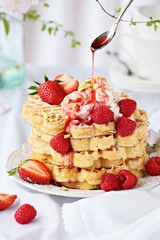 Waffles with fresh seasonal berries and whipped cream. 
