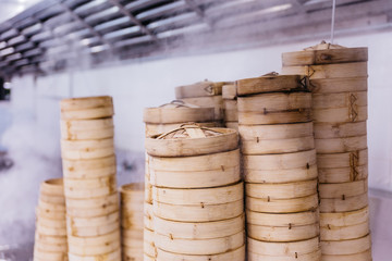 Piles of stacking bamboo steamers are steaming for dim sum.