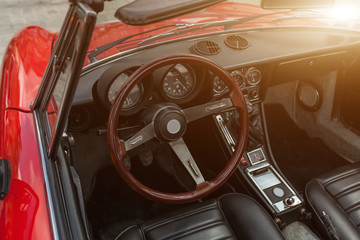 Retro style classic red car interior with matching dashboard