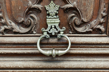 close up of the knocker on the old vintage door