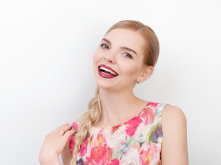 Beauty portrait of young beautiful cheerful young fresh looking woman with bright trendy make up blond healthy hair braid hairstyle.