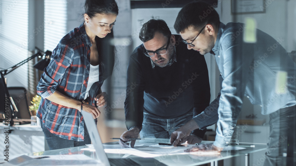 Poster team of design engineers collectively work on the project. they inspect drafts, documents and have d