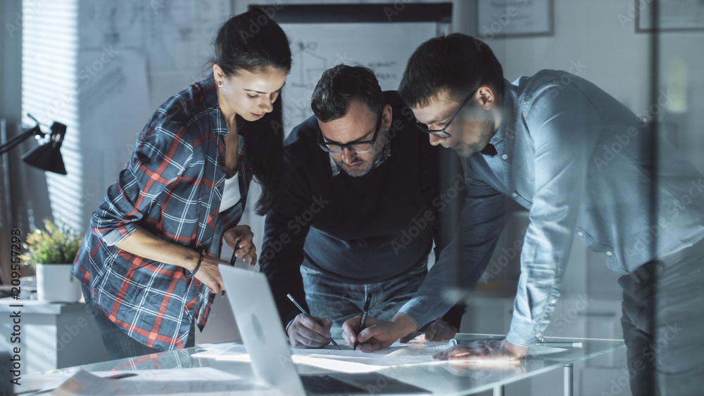 Poster team of design engineers collectively work on the project. they inspect drafts, documents and have d