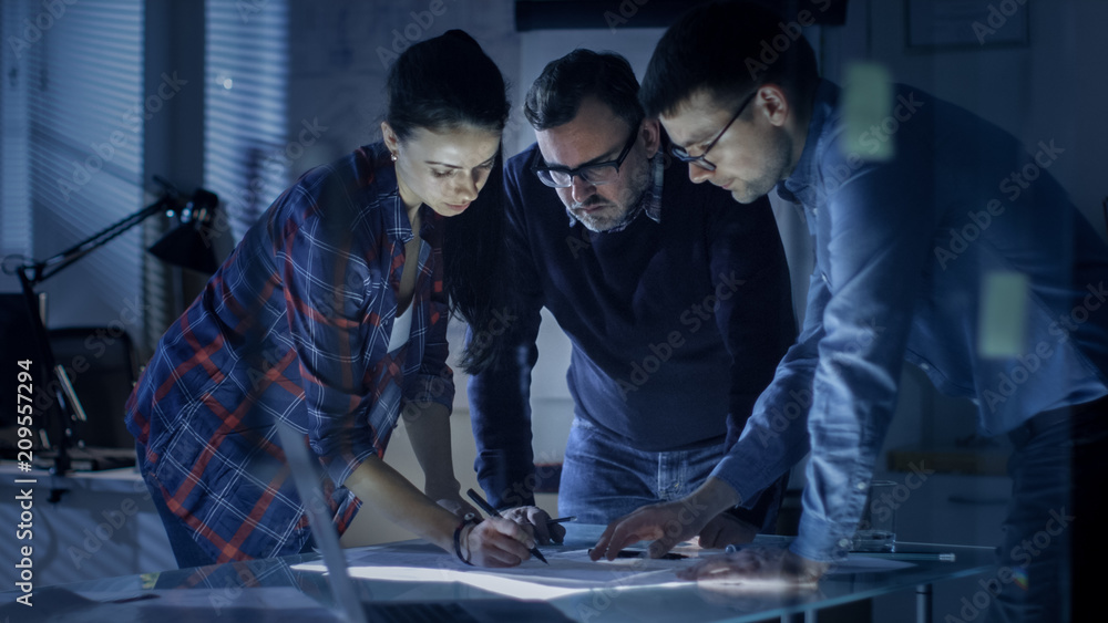 Poster late at night team of design engineers collectively work on the project. they inspect drafts, docume