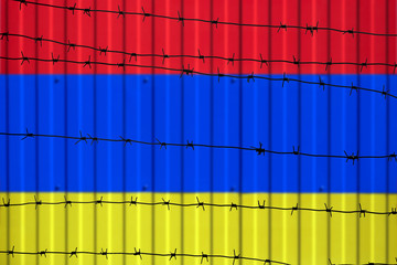 National flag of Armenia on fence. Barbed wire in the foreground symbolizes entry ban or prohibition for crossing border of country
