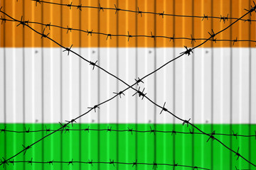 National flag of India on fence. Barbed wire in the foreground symbolizes entry ban or prohibition...