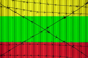 National flag of Myanmar (Burma) on fence. Barbed wire in the foreground symbolizes entry ban or...