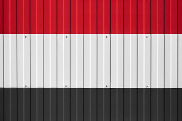 National flag of Yemen on fence. Symbolizes entry ban or prohibition for crossing border of country