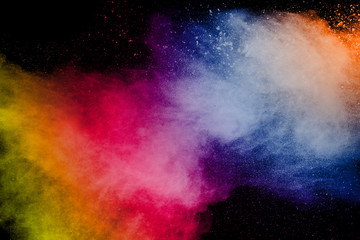 Abstract multi color powder explosion on black background.  Freeze motion of color dust  particles splash. Painted Holi in festival.