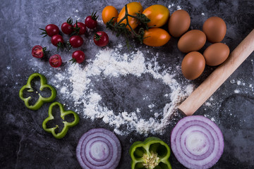 Wheat flour and fresh vegetables on table. Homemade pastry for bread, pizza or pie. Bakery background