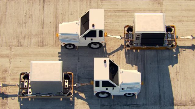 Transport of cargo containers at airport by a baggage Tug during sunny day. 4KHD