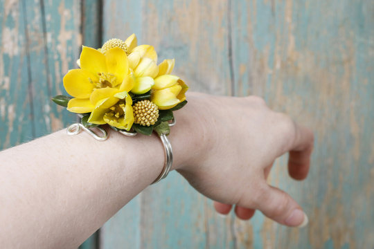Wrist corsage made of yellow flowers.