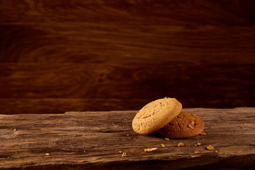 Pile of oat cookies on wooden table, close-up, selective focus.