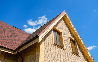 Slate roof background. New modern architectural building of the house. large panoramic Windows. Against the blue sky.