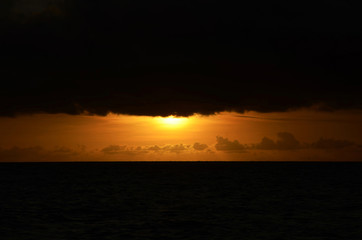 Sunset time at a beautiful island with orange gradient colour of sky and people playing around the...