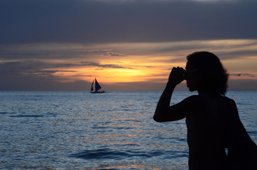Sunset time at a beautiful island with orange gradient colour of sky and people playing around the...
