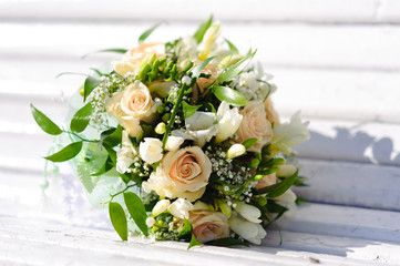 Bouquet of a bride on a white bench. Beautiful wedding bouquet. 