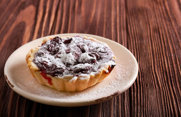 Cherry mini tart with icing sugar