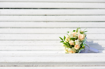 Fototapeta na wymiar Bouquet of a bride on a white bench. Beautiful wedding bouquet. 