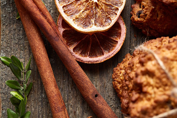 Christmas composition with oatmeal, chocolate biscuits, and spices, on wooden background, close-up, selective focus.