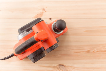 top view of the electric planer on a wooden table