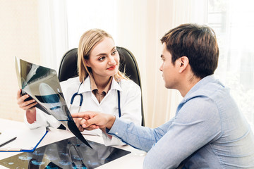 Fototapeta premium Female doctor looking at x-ray photo in hospital.healthcare and medicine