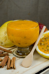 Healthy dessert made with passion fruit, mango and cinnamon, served in a glass bowl