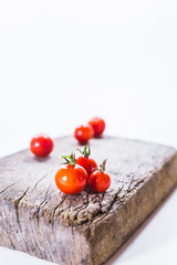 Fresh grape tomatoes on wood board. 