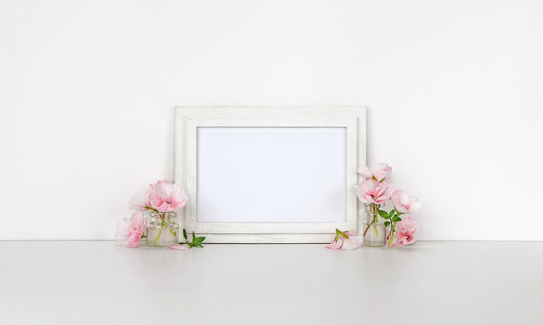 Horizontal wooden frame mockup, little bottles with pink flowers