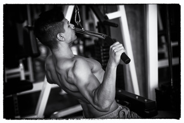 Portrait of young man using weight lifting equipment , back and white tone style, bodybuilder concept.