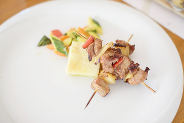 lamb kebab on a white plate