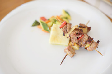 lamb kebab on a white plate
