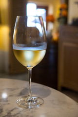 A glass of wine on the table, with blur background in the restaurant