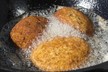 Scottish eggs fried in a pan